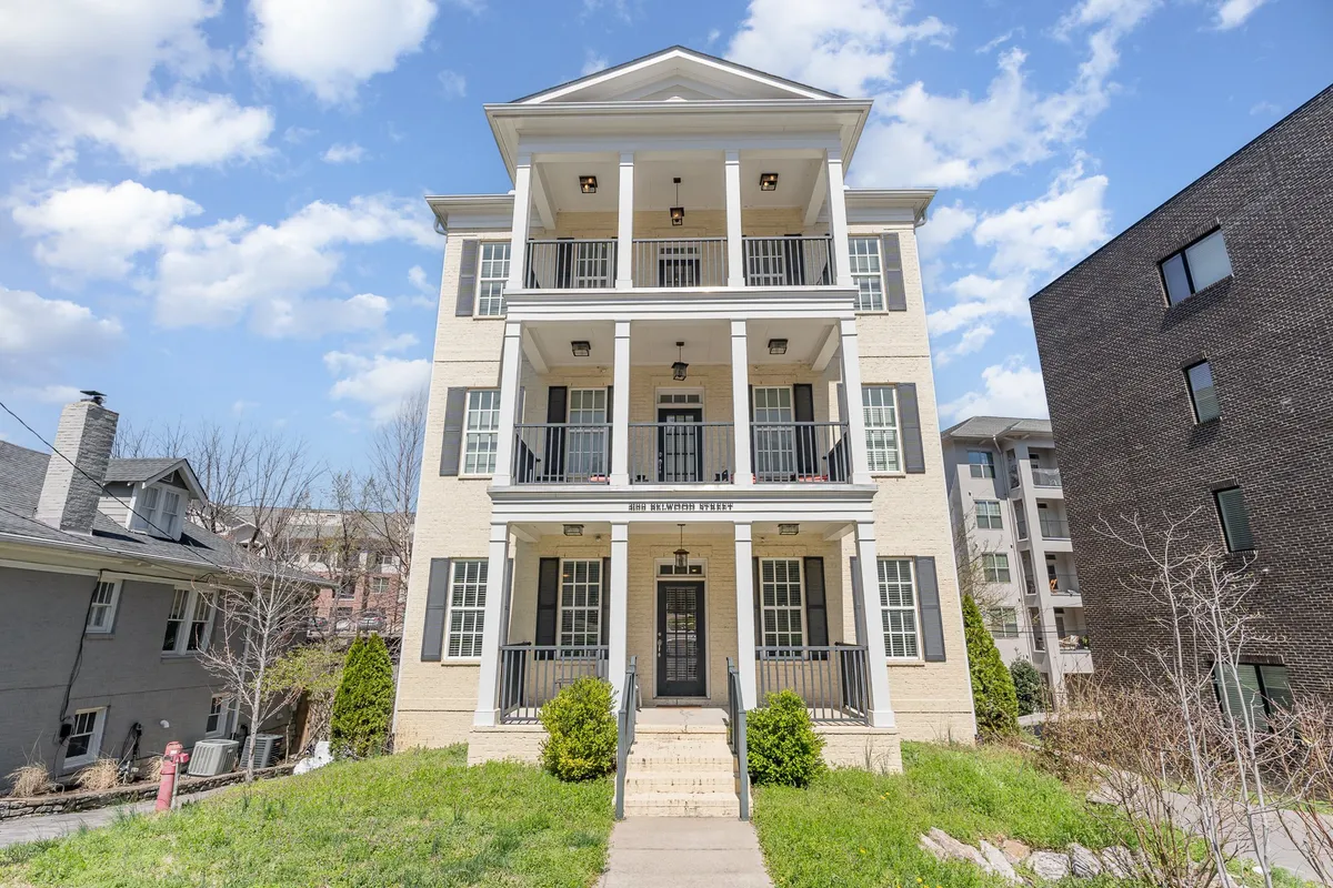 A welcoming exterior shot of a three-story residential building with front entrance and balconies, suggesting relaxation and community. The image implies comfort and a tranquil retreat after a busy day in the city.