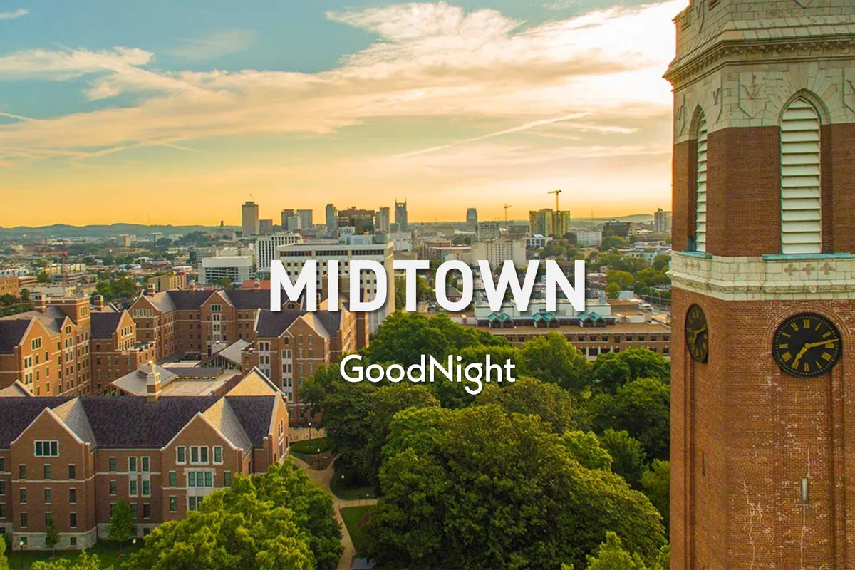 A serene and expansive view of the Midtown Nashville skyline, featuring the clock tower, historic buildings, and lush green trees. The image captures the vibrancy and accessibility of Nashville’s core, suggesting ease of access to business and cultural venues.