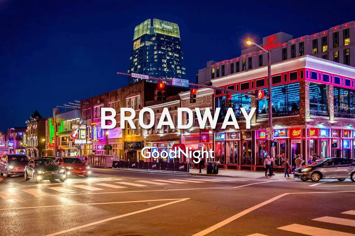 This image captures a vibrant urban street at night, illuminated by neon signs and bustling with activity. Tall buildings line the busy street, while traffic lights and crowds of people hint at the city's thriving nightlife and live music scene.